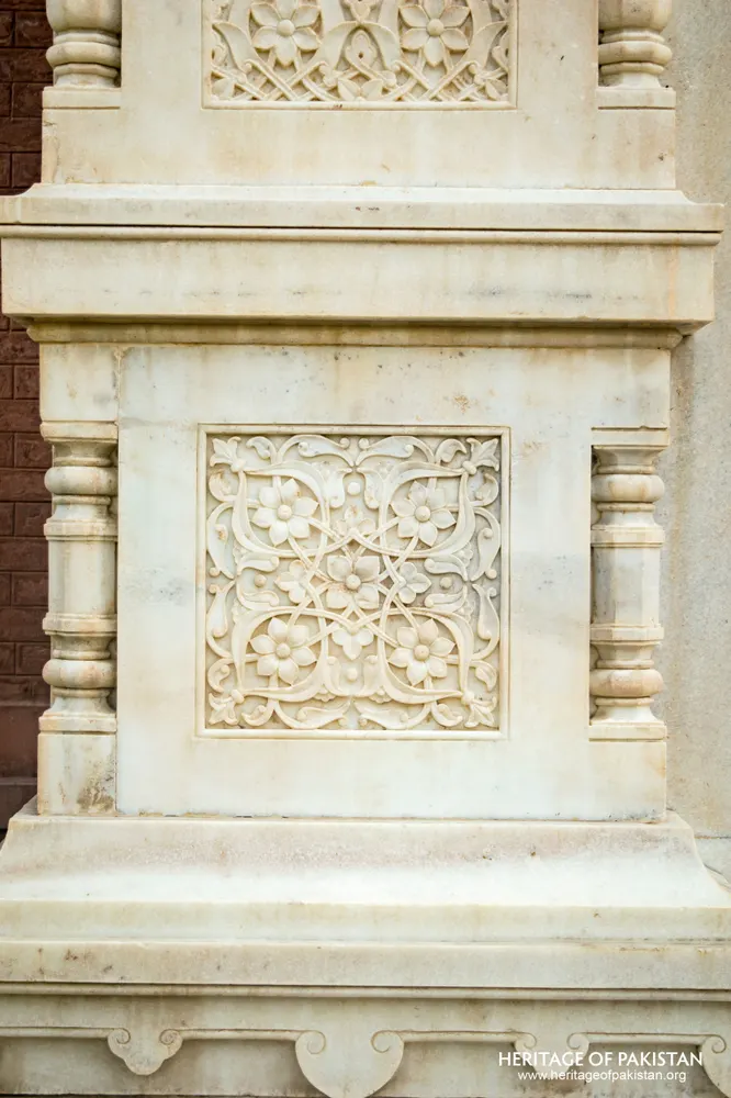 White marble plinth panel carved with floral scroll pattern