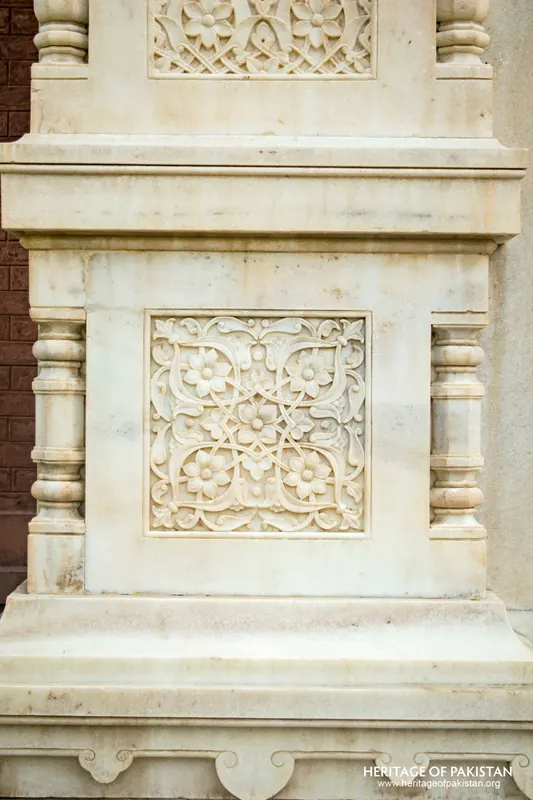 White marble plinth panel carved with floral scroll pattern