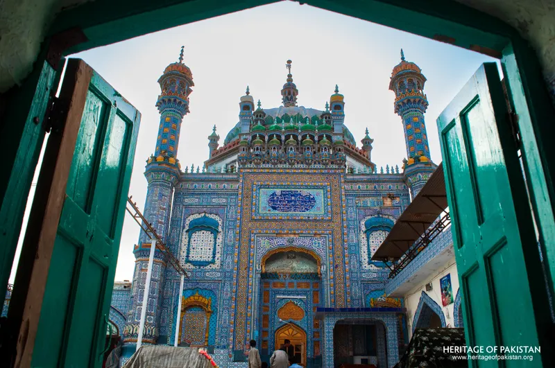 The shrine seen through green double doors from a tiled passage