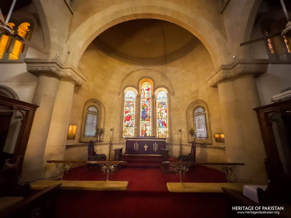 Apse of Holy Trinity Church with the altar beneath the stained-glass triptych window