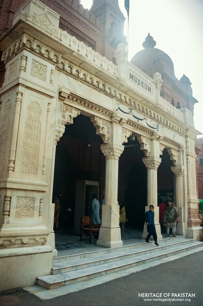 White marble portico with carved arches and columns