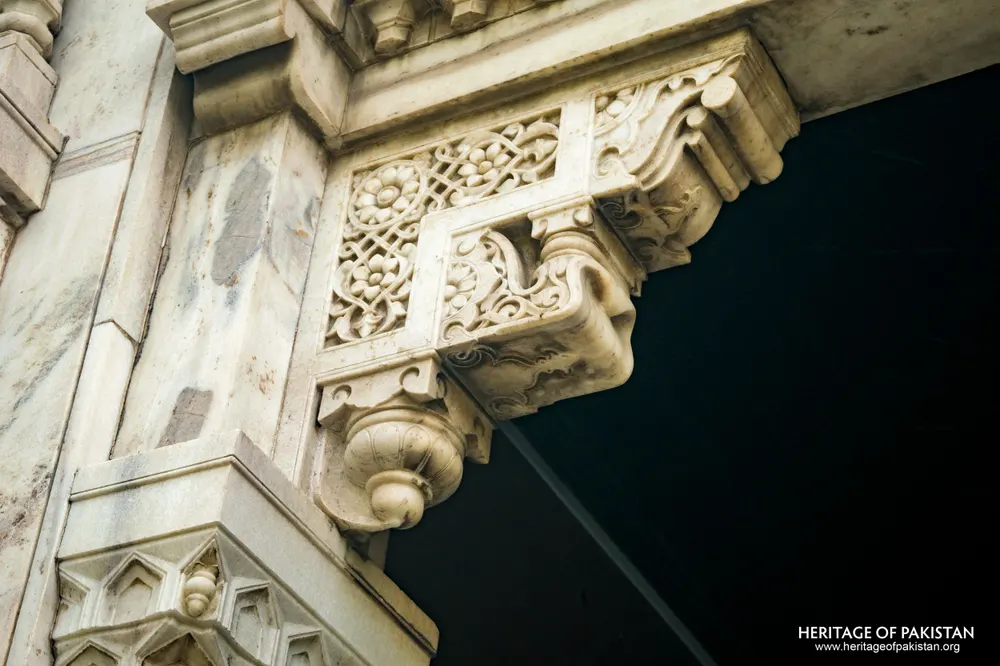 Carved marble bracket with floral panel and scroll volute