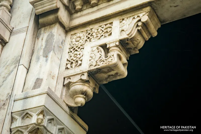 Carved marble bracket with floral panel and scroll volute