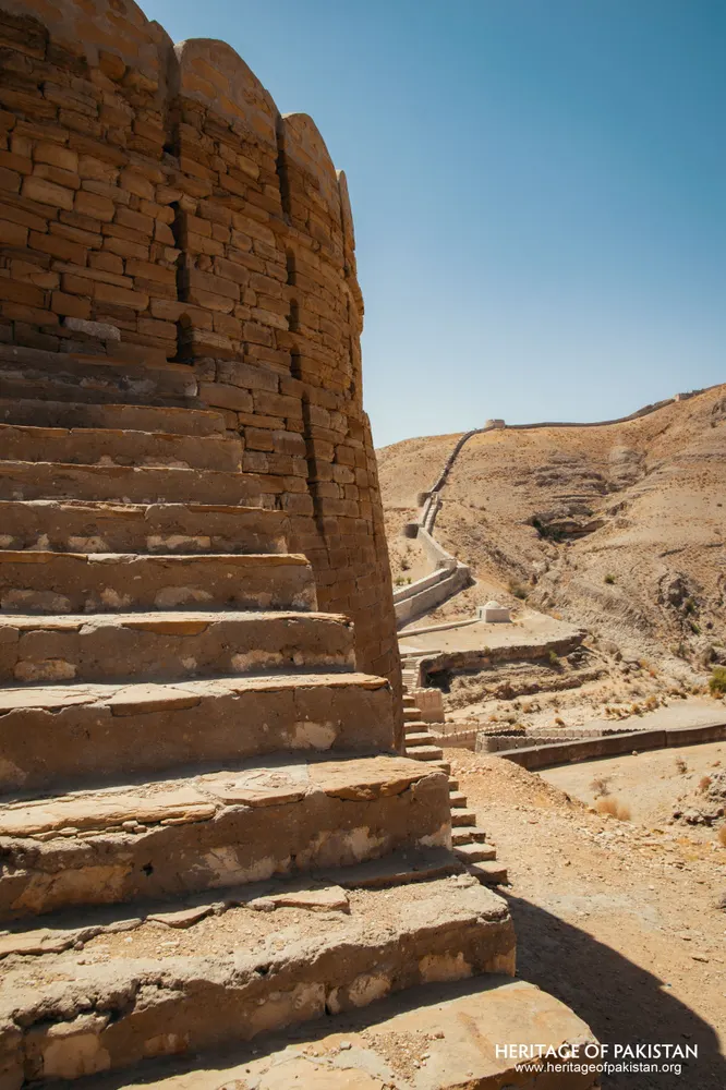 Stone staircase rising beside a rounded rubble bastion