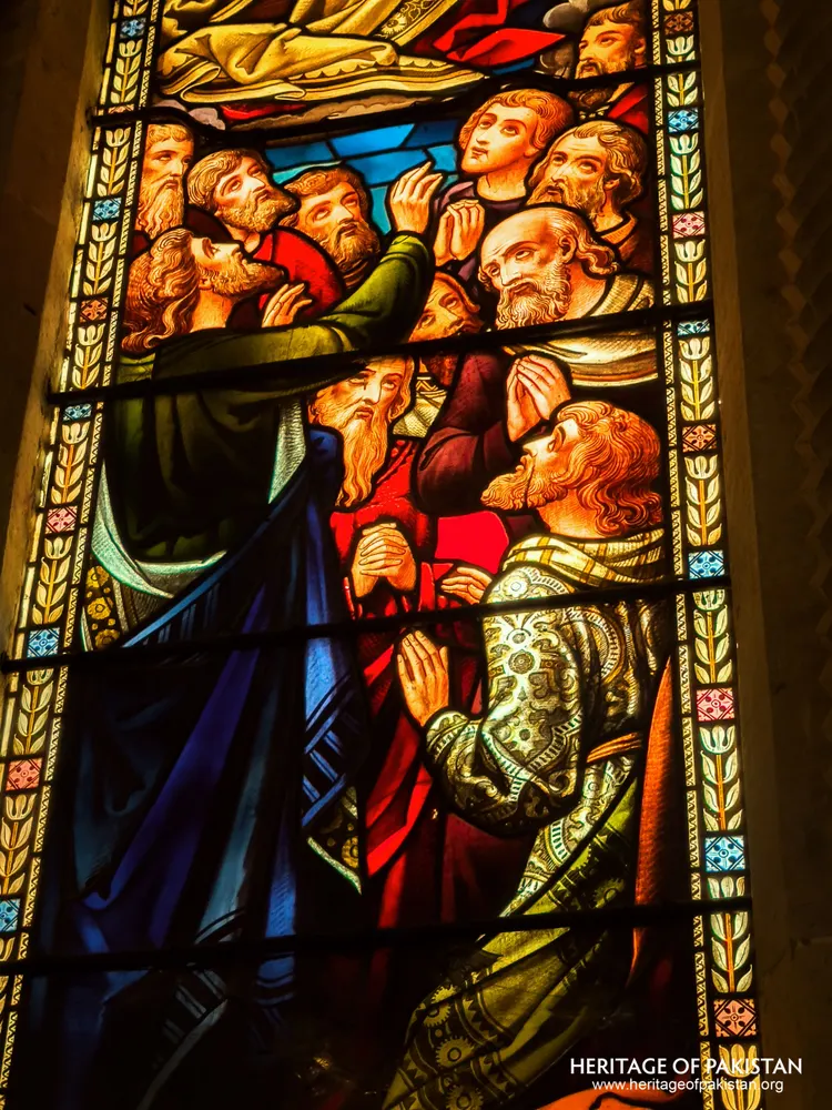 Stained-glass panel of apostles gathered in prayer at Holy Trinity Church