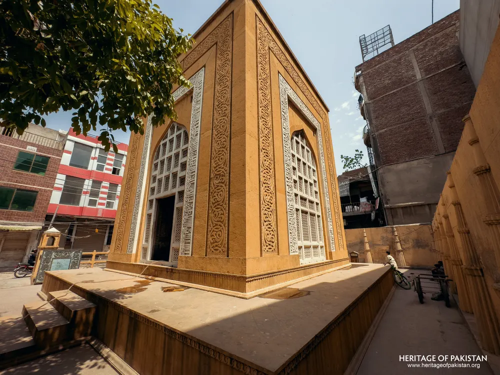 Yellow sandstone structure with white lattice screens and carved panels