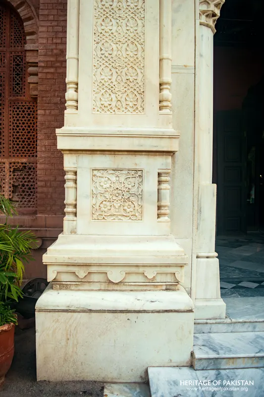 Base of a white marble pier with carved square panel