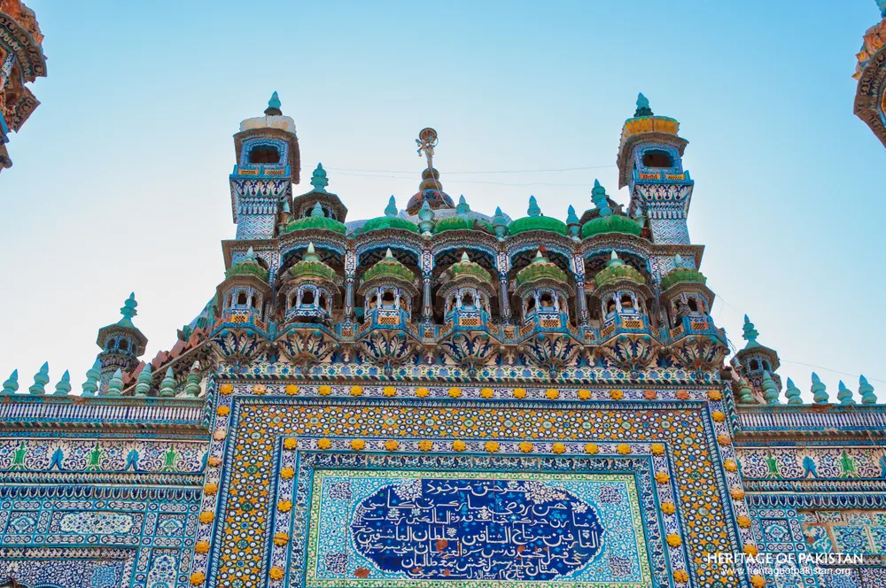 Row of green-domed kiosks along the shrine's upper facade
