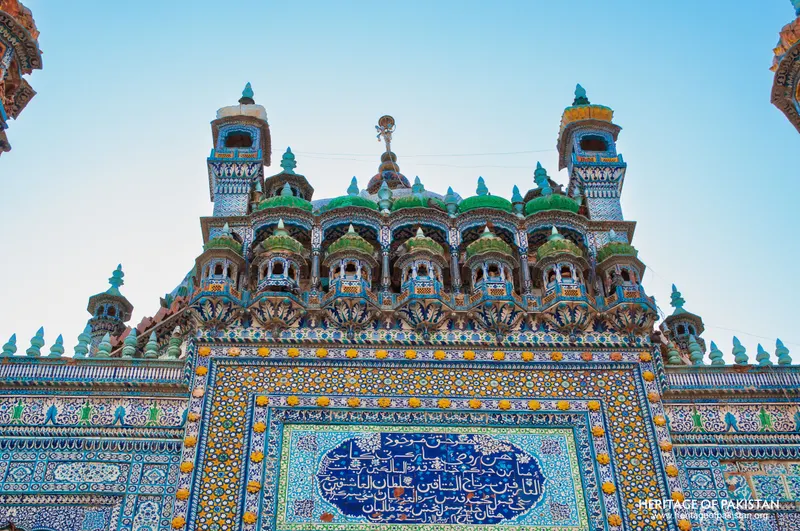 Row of green-domed kiosks along the shrine's upper facade