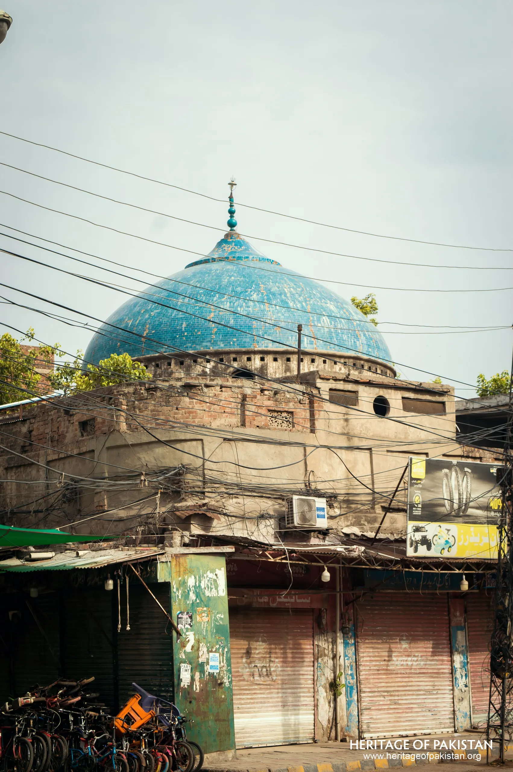 On Mall Road in Lahore, near Anarkali Bazaar, a turquoise dome rises above a cycle market.