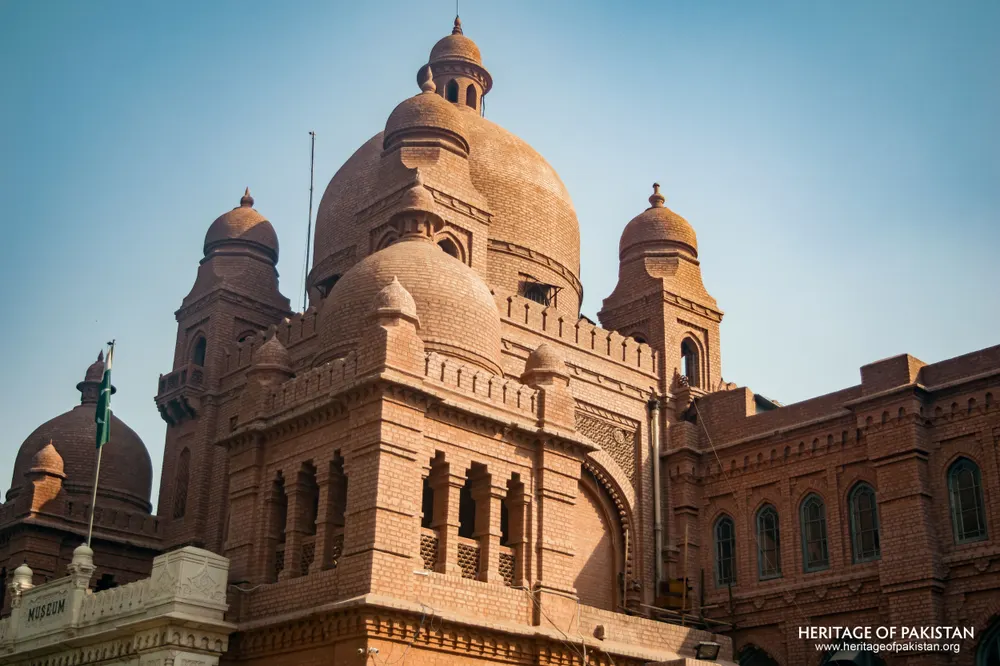 Close-up of red brick domes and carved arched windows