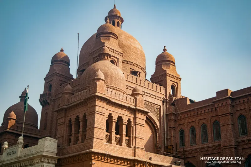 Close-up of red brick domes and carved arched windows