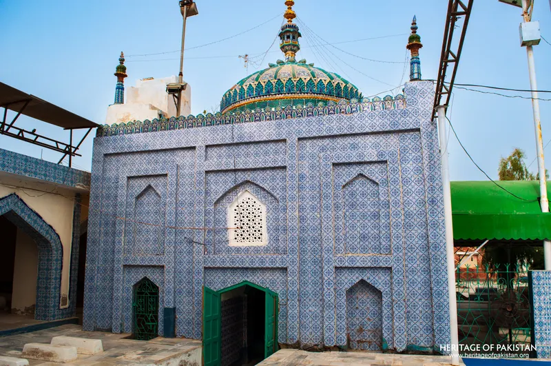 Tomb chamber of the shrine with a green dome and blue-tiled walls
