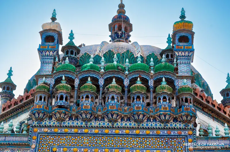 Green-glazed domes and honeycombed tiers crowning the shrine roof