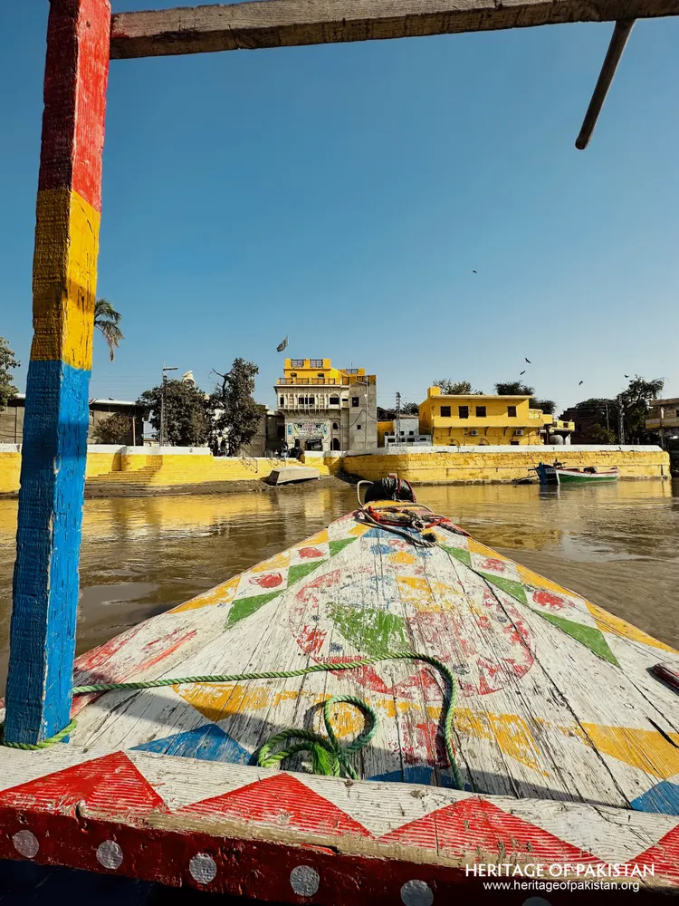 Approaching Sadhu Belo Temple island by painted wooden boat on the Indus River