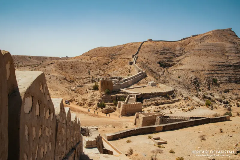 Stone wall and bastions curving across an arid plain