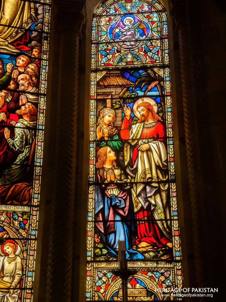 Close-up of a stained-glass panel showing a healing scene at Holy Trinity Church