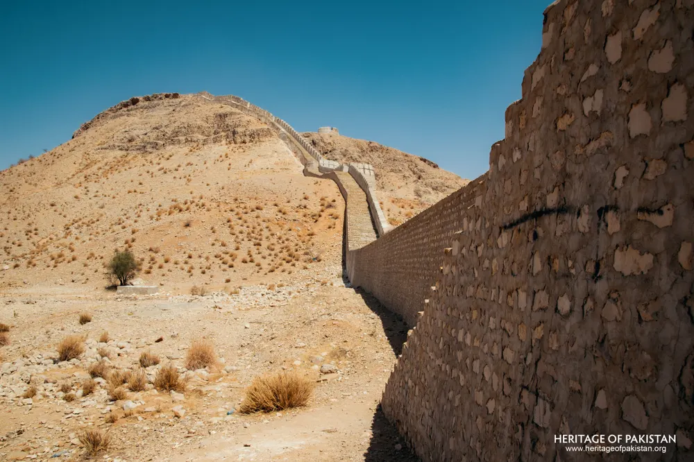 Rubble stone wall running to a bare hilltop