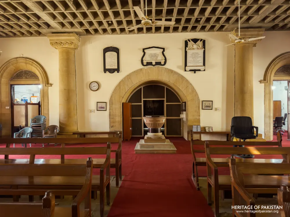 Baptistery chamber with a marble font beneath a coffered wooden ceiling at Holy Trinity Church