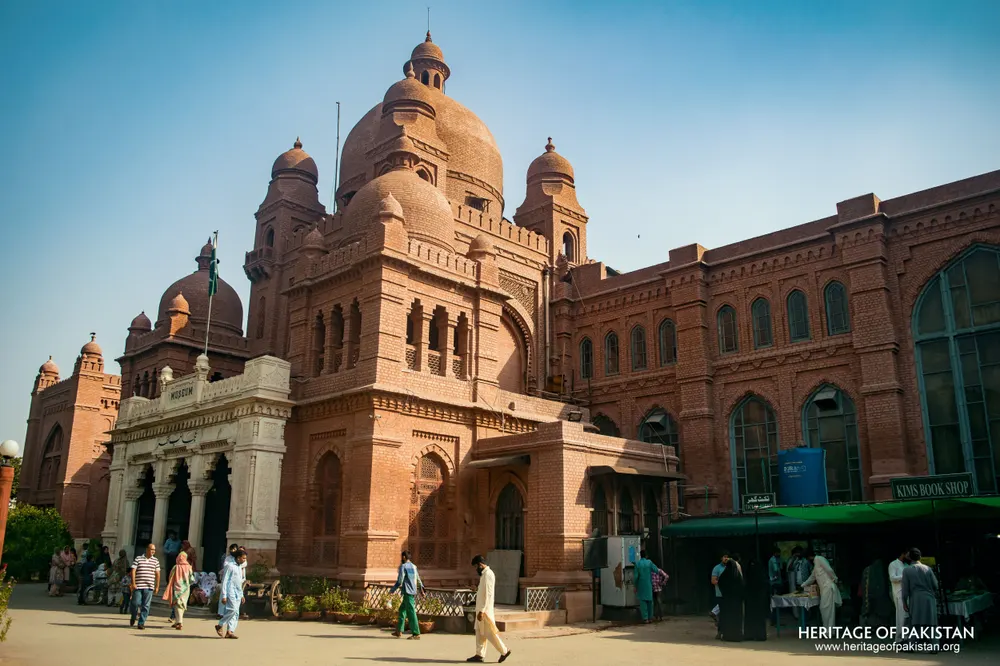 Red brick building with a large central dome and white marble portico