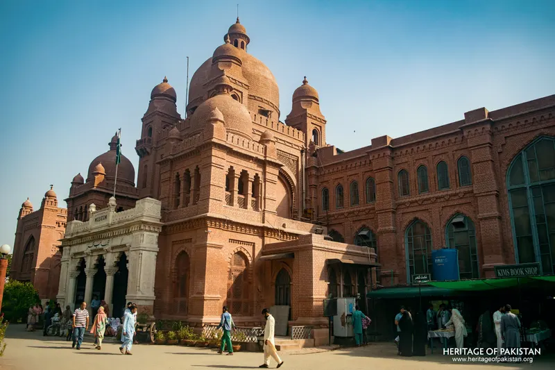 Red brick building with a large central dome and white marble portico