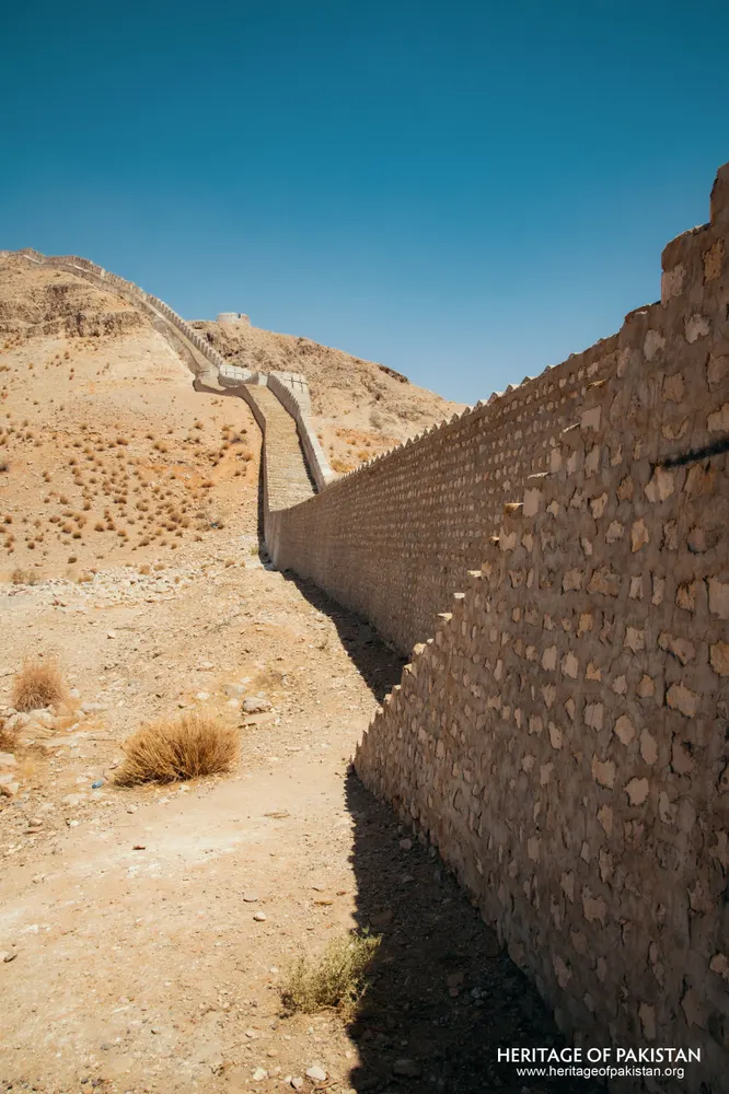 Rubble stone wall climbing a dry hillside