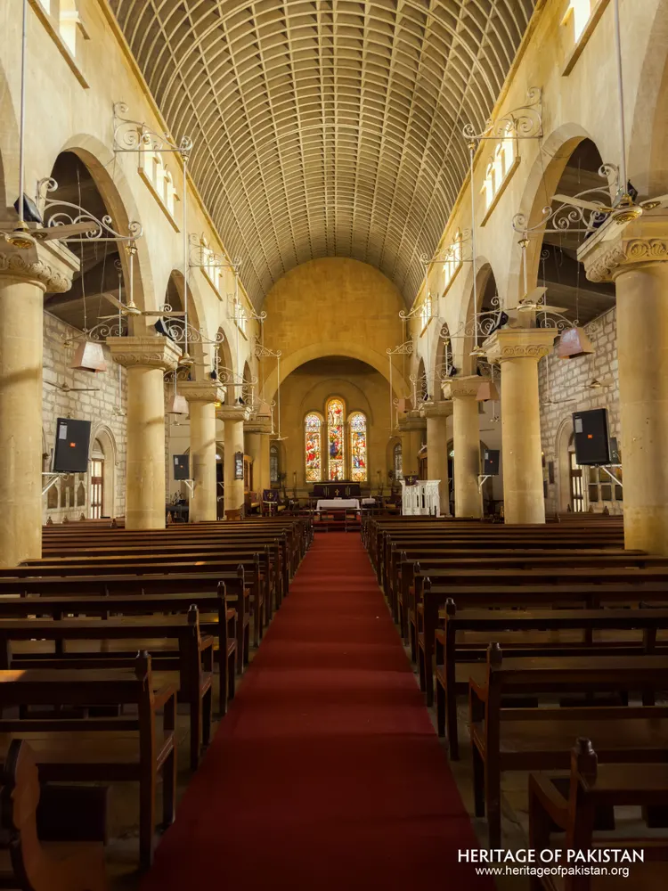 Symmetrical view down the nave of Holy Trinity Church toward the illuminated altar