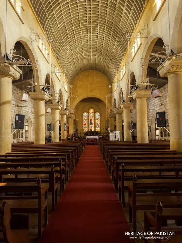 Symmetrical view down the nave of Holy Trinity Church toward the illuminated altar
