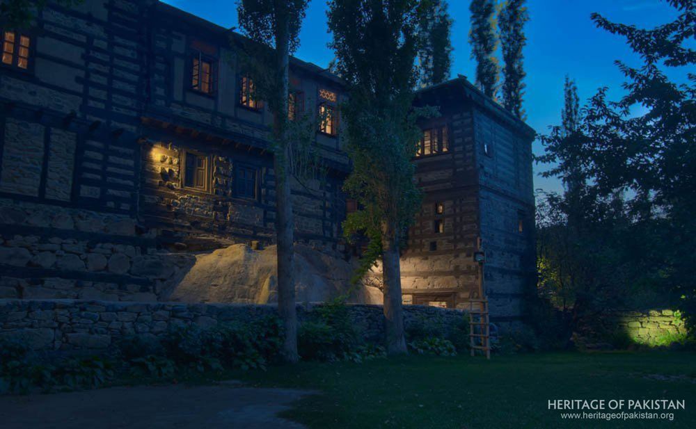 Evening light reveals the layered timber-and-stone structure of the historic fort.