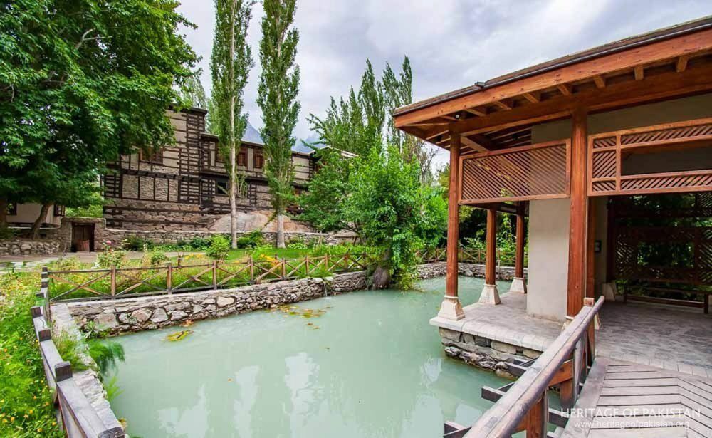 The pavilion anchors Shigar Fort's serene pond and garden sanctuary.