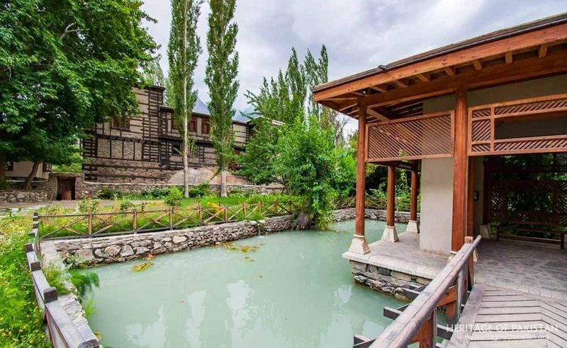 The pavilion anchors Shigar Fort's serene pond and garden sanctuary.