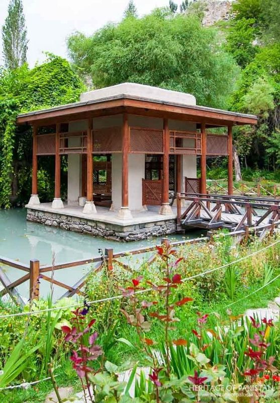 Colorful gardens frame the pavilion's reflection in Shigar Fort's pond.