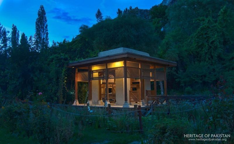 Warm light spills from the garden pavilion into Shigar Fort's twilight landscape.