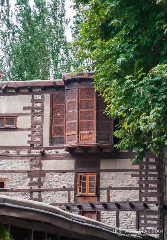 Carved wooden jharoka bay projects from Shigar Fort's southern elevation.