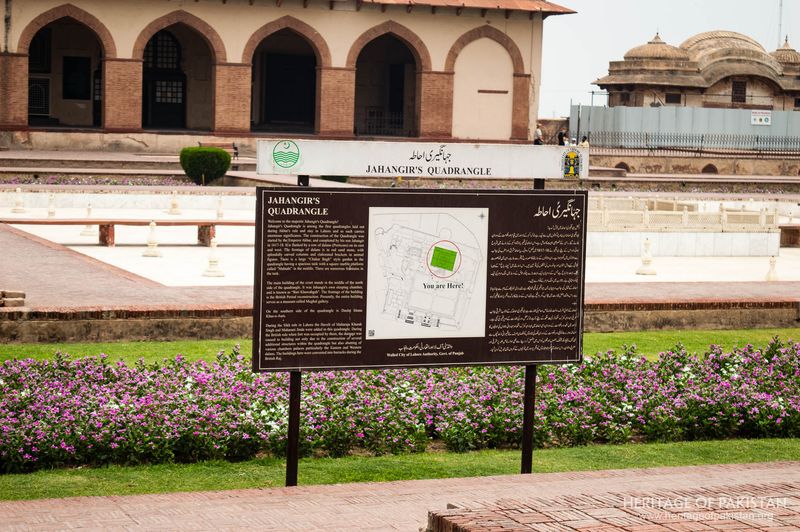 An interpretive marker explains the history framed by the structure's distinctive arched