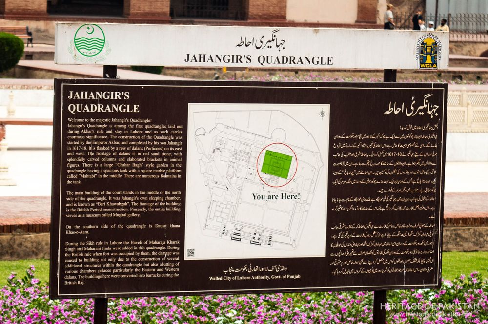 Detailed interpretive signage preserves history within the elegant courtyard setting.