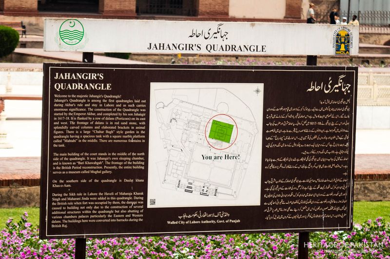 Detailed interpretive signage preserves history within the elegant courtyard setting.