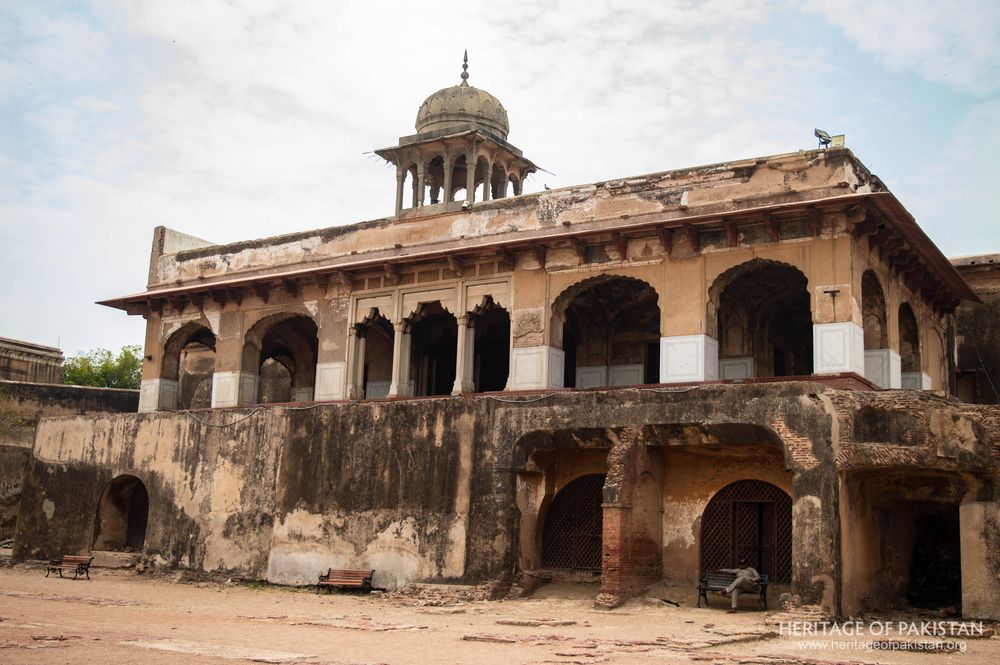 A layered facade reveals centuries of use, with upper and lower levels