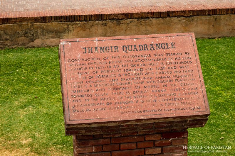 An engraved heritage marker documents the site's construction and transformation through eras.