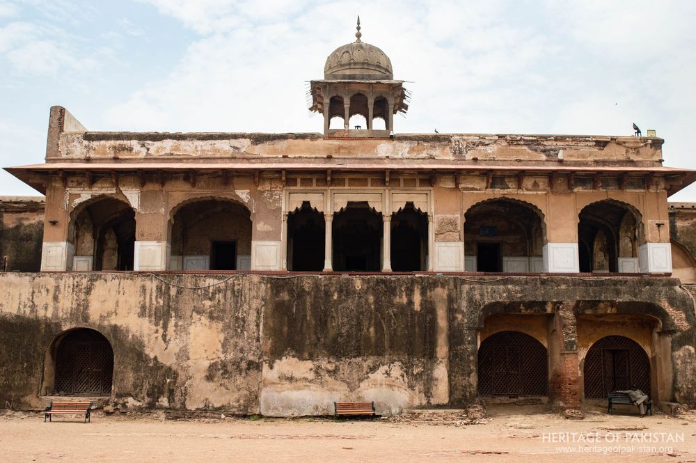 Weathered lower chambers contrast with ornate upper pavilion