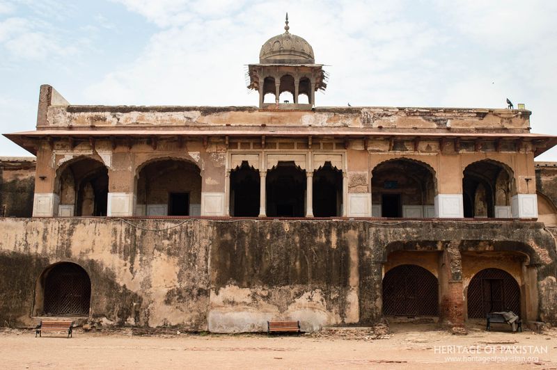 Weathered lower chambers contrast with ornate upper pavilion