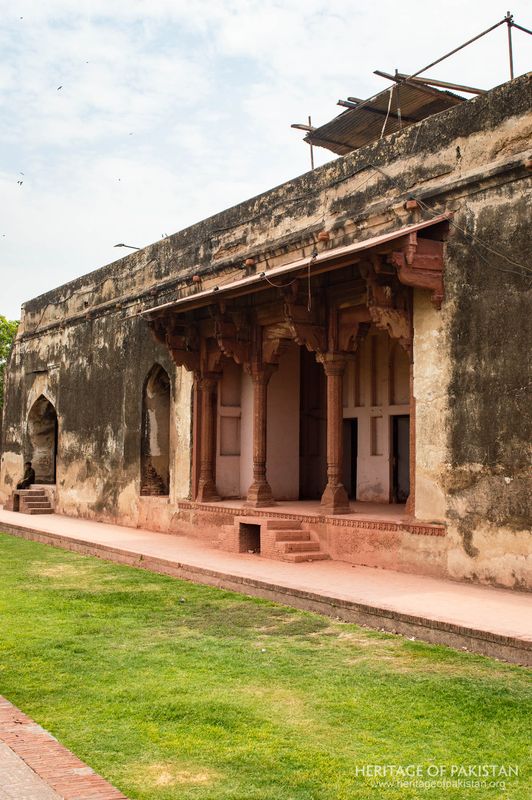 Detailed view of the eastern arcade with carved red sandstone elements.